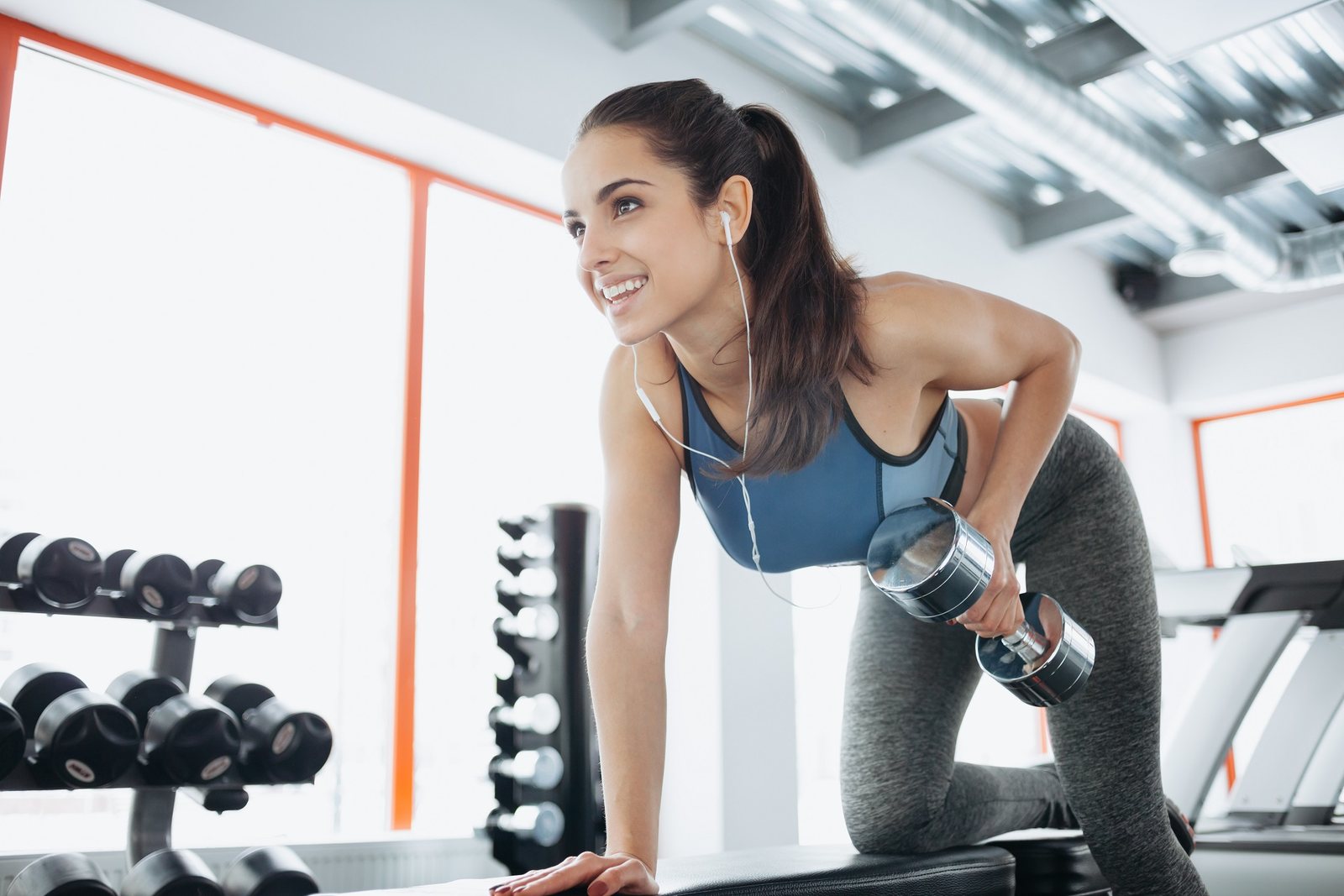 Fitness professional training with a dumbbell in a gym