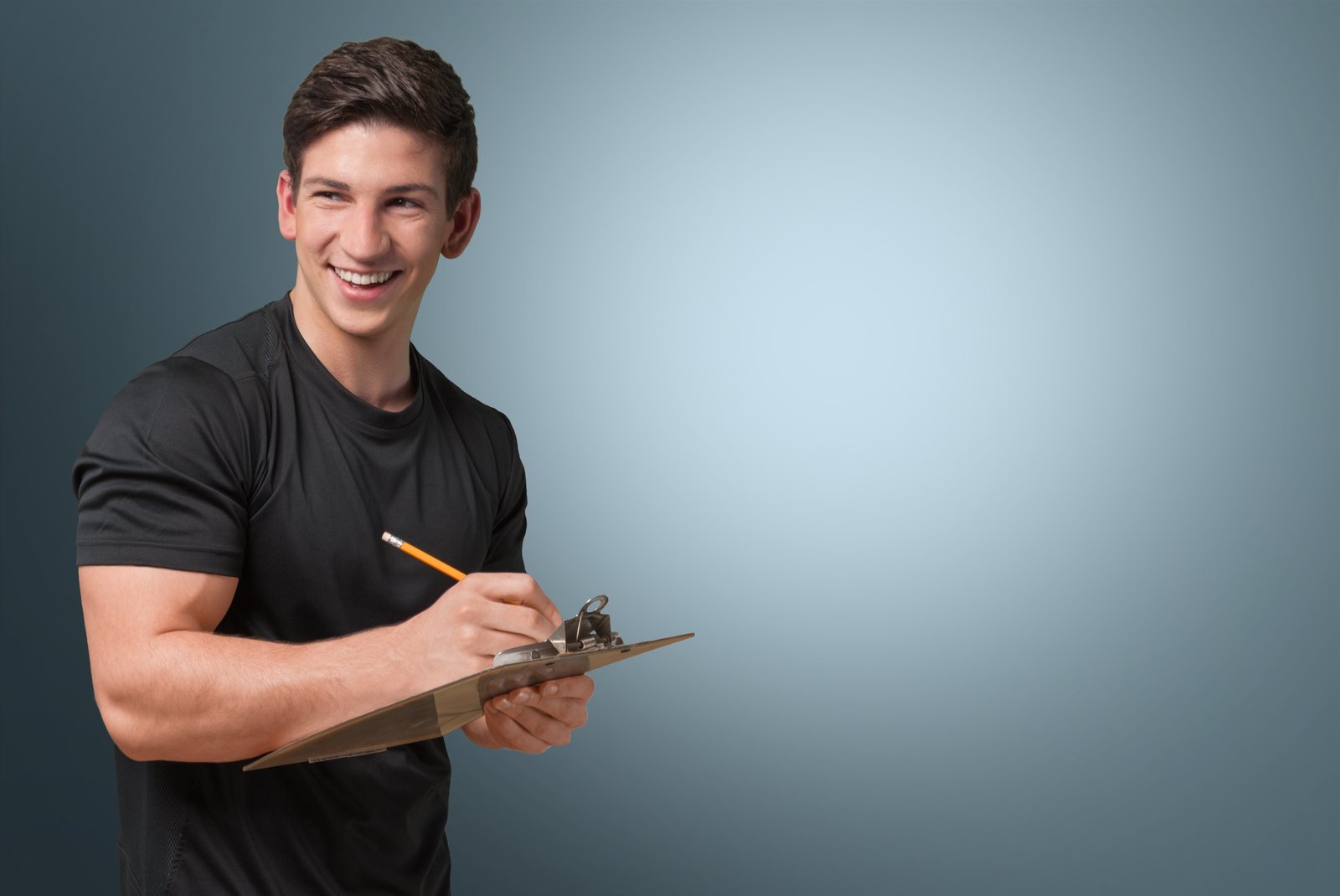 Fitness professional reviewing client notes on a clipboard